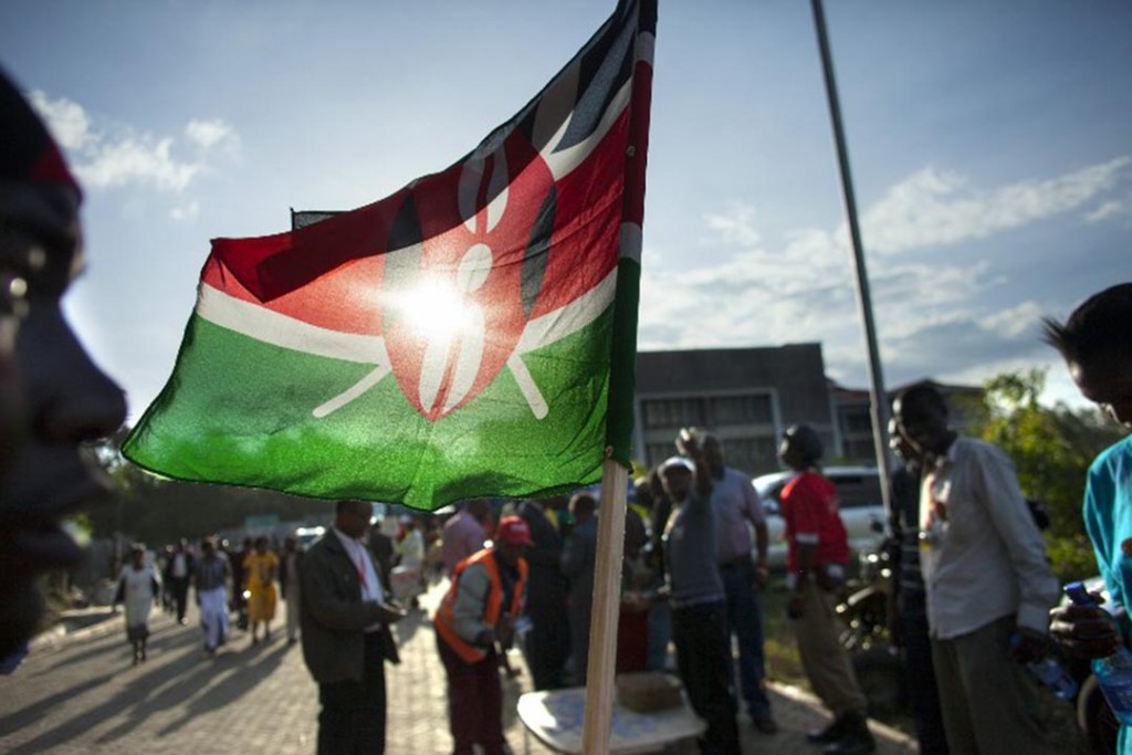 A supporter of Kenyan presidential candidate Uhuru Kenyatta sells Kenyan flags at the Catholic University where Uhuru Kenyatta gave the acceptance speech of his victory in Kenya's national elections on March 9, 2013 in Nairobi. Uhuru Kenyatta narrowly won Kenya's presidential election, final results showed on Saturday, but his main rival refused to concede, raising tensions following the key poll. AFP PHOTO / GEORGINA GOODWIN / AFP PHOTO / Georgina Goodwin