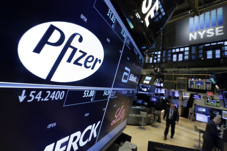 The Pfizer logo appears on a screen above its trading post on the floor of the New York Stock Exchange, Wednesday, April 6, 2016. The biggest U.S.-based drugmaker, Pfizer Inc., will stay put thanks to aggressive new Treasury Department rules that succeeded in blocking Pfizer from acquiring rival Allergan and moving to Ireland, on paper, to reduce its tax bill. (AP Photo/Richard Drew)