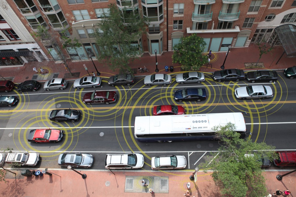 An artist’s conception visualizes how “connected vehicles” could communicate. (Credit: USDOT)