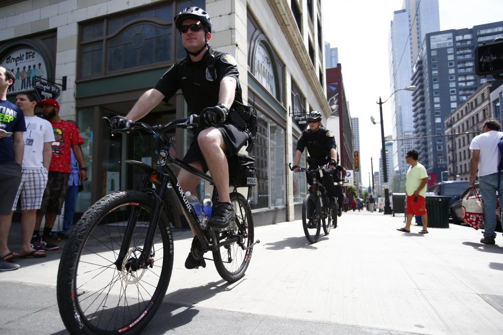 Seattle Police officers ride their bikes downtown on 2nd Ave. and Pine St., on May Day, Thursday, May 1, 2014.