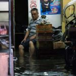 _96328129_hi039826813-afp-amansitsinhisfloodedhomeduringheavyraininjinshannewtaipeicityonjune22017.heavyrainstriggeredfloodingalongtaiwansnorthcoastanddisruptedtrafficinthearea