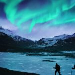Hikers Under the Northern Lights