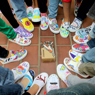 Children celebrate their unique designs at a recent 'Mockups' workshop conducted by artist, educator, and Mockups designer Louie Gong. Mockups is a Do-It-Yourself shoe-inspired art toy that launched last month. Photo: Eighth Generation, LLC